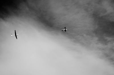 Low angle view of airplane flying in sky