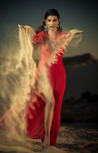 Portrait of young woman standing outdoors