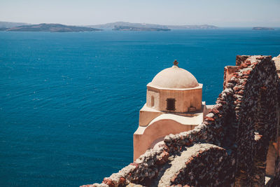 View of built structure by sea