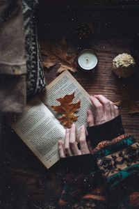 Cropped hand of woman reading book