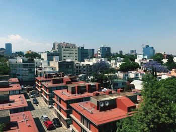 High angle view of buildings in city against clear sky