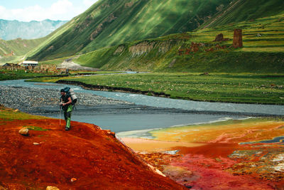 Rear view of man walking on mountain