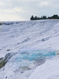 Scenic view of white calcium natural pools against sky 