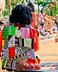 Rear view of woman with multi colored umbrella