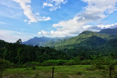 Scenic view of mountains against blue sky