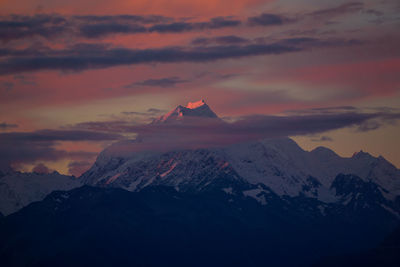 Scenic view of snowcapped mountains against sky during sunset