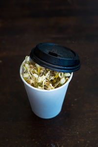 Bean sprouts, mung bean and taugeh growing in a recycled coffee cup. often used in asian dishes