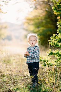 Portrait of girl standing on field