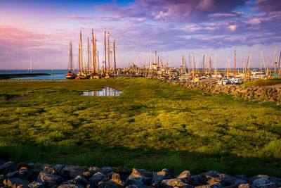 Scenic view of harbour against sky during sunset