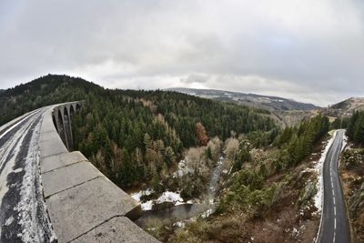 Panoramic shot of road by mountain against sky