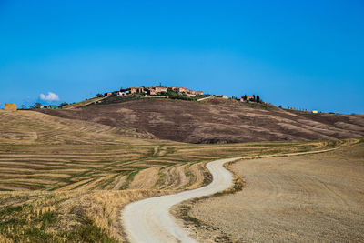 Scenic view of land against clear blue sky