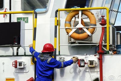 Rear view of engineer working at boat