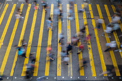 Blurred motion of people walking on road