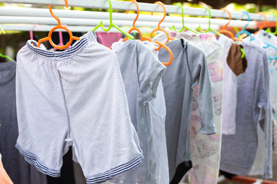 Close-up of clothes hanging on rack