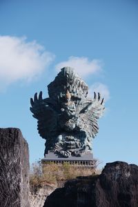 Low angle view of statue against cloudy sky