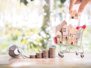 Cropped hand of woman holding coins on table