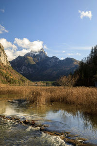 Scenic view of lake and mountains against sky