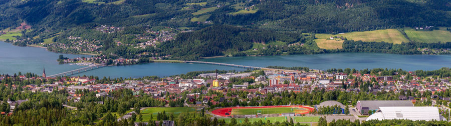 High angle view of trees and buildings by lake in city