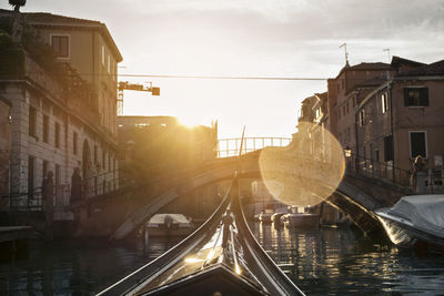 Gondola on canal in city during summer