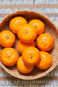 High angle view of orange fruits in basket