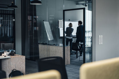 Professional team working together in board room at office