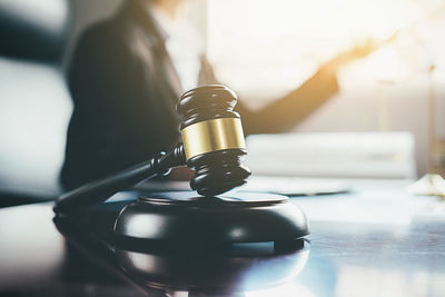 Midsection of lawyer working at desk in office