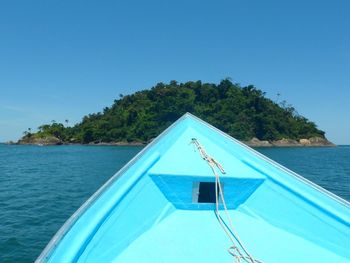 Sailboat in swimming pool against clear blue sky