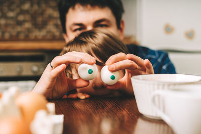 Easter day with kid. father and son with funny face and egg eyes fun together. family man and child