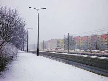 Snow covered city against sky