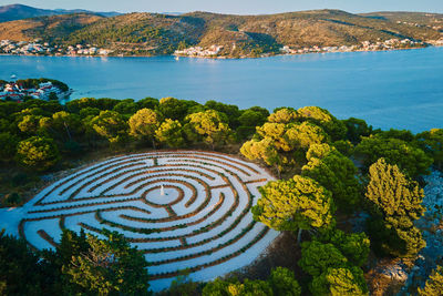 Panoramic view of islands in adriatic sea and hedge maze among forest trees
