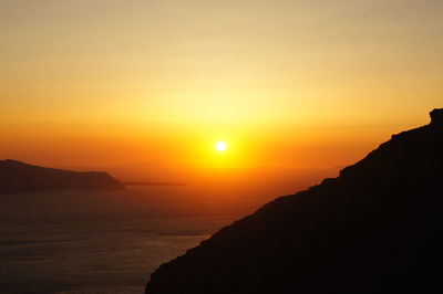 Scenic view of sea against romantic sky at sunset