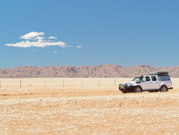 Car parked on land against sky