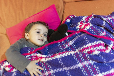 Cute baby girl lying on bed