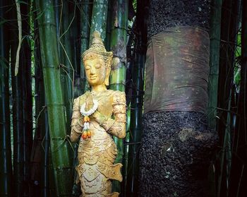 Statue amidst trees in temple