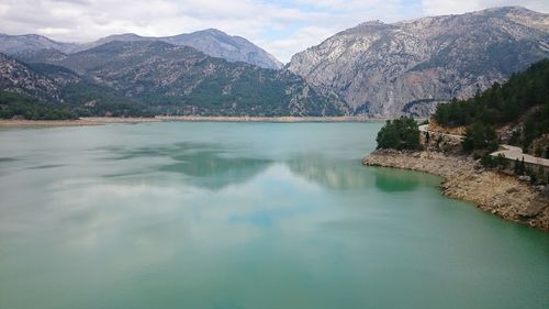 Scenic view of lake and mountains against sky