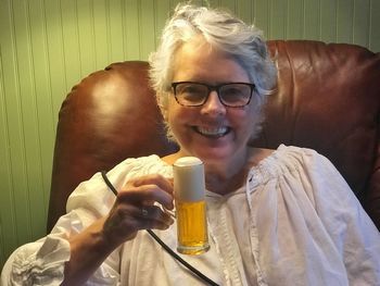 Portrait of smiling man drinking glasses