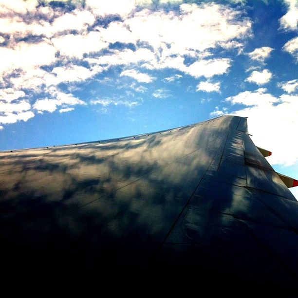 sky, low angle view, cloud, cloud - sky, built structure, outdoors, day, no people, sunlight, blue, cloudy, part of, architecture, diminishing perspective, nature, pattern, cropped, close-up, beauty in nature, tranquility