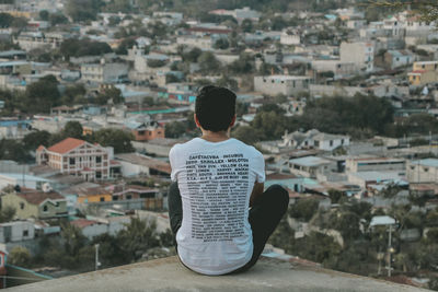 Rear view of man with cityscape