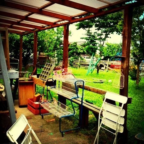 chair, empty, table, absence, bench, seat, tree, furniture, indoors, wood - material, restaurant, sunlight, day, park bench, relaxation, grass, built structure, tranquility, green color, place setting