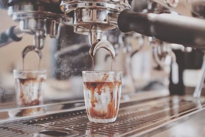 Close-up of pouring coffee in cafe