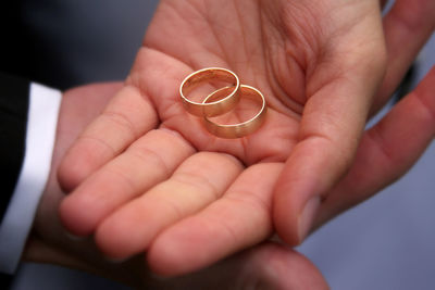 Close-up of man holding engagement rings