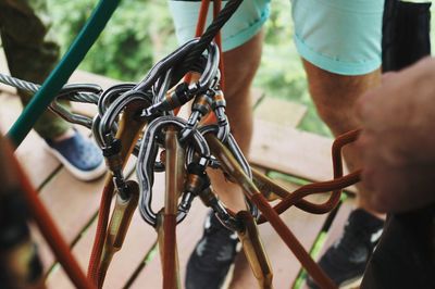 People by safety harnesses on wood