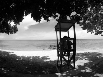 Lifeguard hut on beach against sky