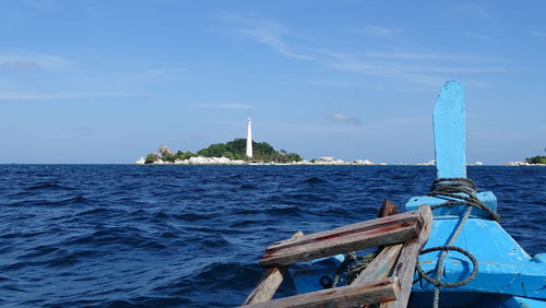 Boat in sea against blue sky