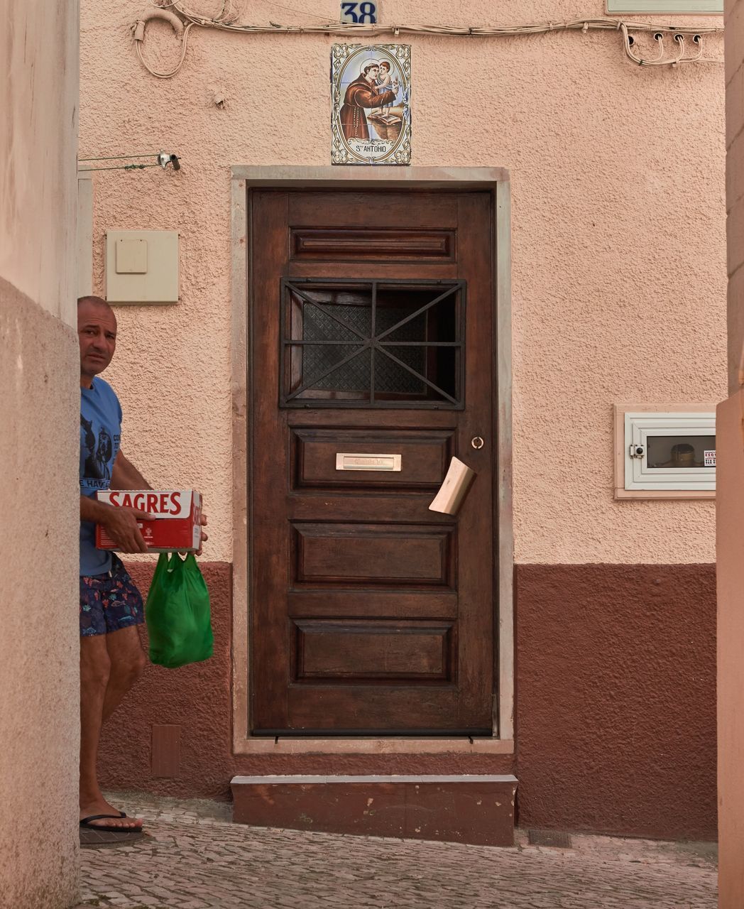 MAN STANDING OUTSIDE HOUSE