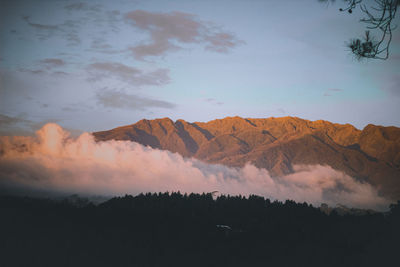 Scenic view of silhouette mountains against sky during sunset