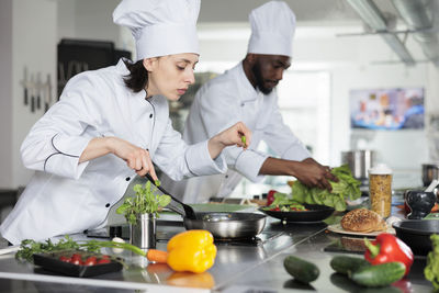 Chef cooking meal in restaurant kitchen