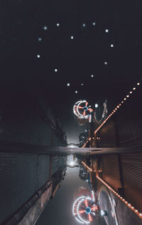 View of illuminated bridge in city at night