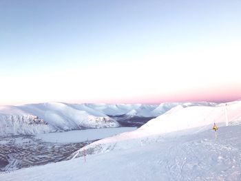 Scenic view of snow covered mountains against sky