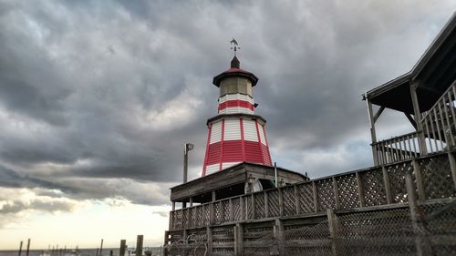 Low angle view of lighthouse against cloudy sky